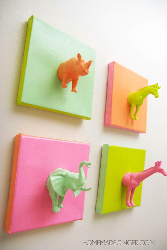 This cute DIY canvas project made with plastic animals is such a fun and easy idea! It's perfect for a nursery, kids' room, or craft studio.