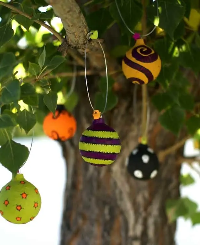 In this budget friendly, recycled Halloween craft, you'll use Mod Podge and old Christmas ornaments to make these cool Halloween ornaments!