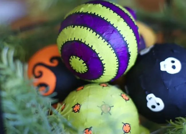 In this budget friendly, recycled Halloween craft, you'll use Mod Podge and old Christmas ornaments to make these cool Halloween ornaments!