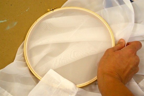 Pull a screen across an embroidery hoop