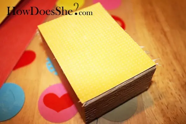 Leave sweet messages for your family with this love note Valentine's Day decor, built with scrap wood and decorated with pretty papers and Mod Podge.