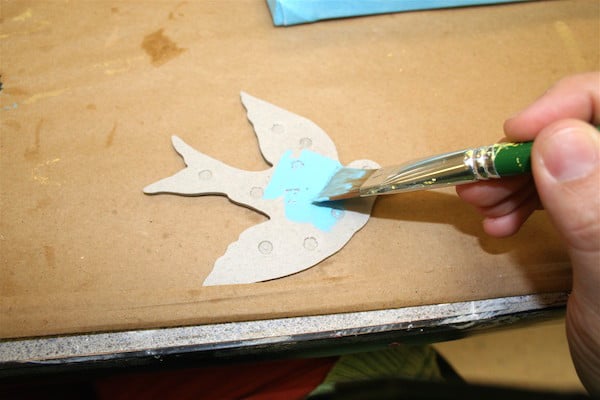 Painting the chipboard with light blue craft paint