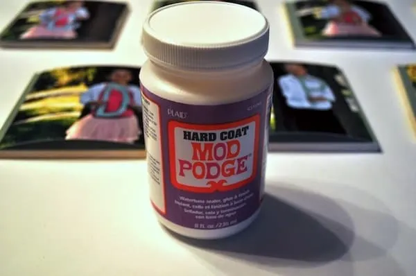 bottle of Hard Coat Mod Podge in front of picture coasters