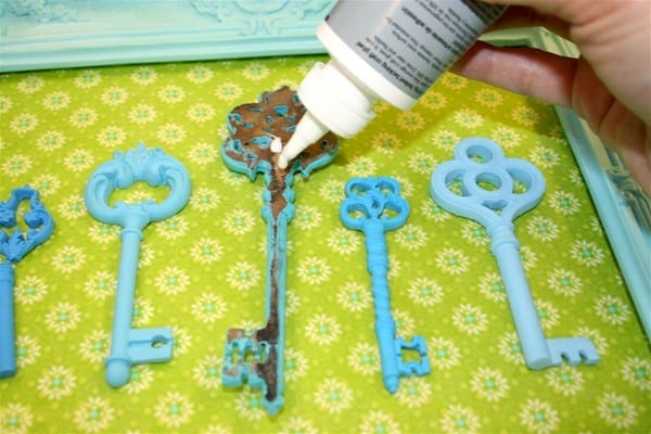 Adding craft glue to the back of a faux key