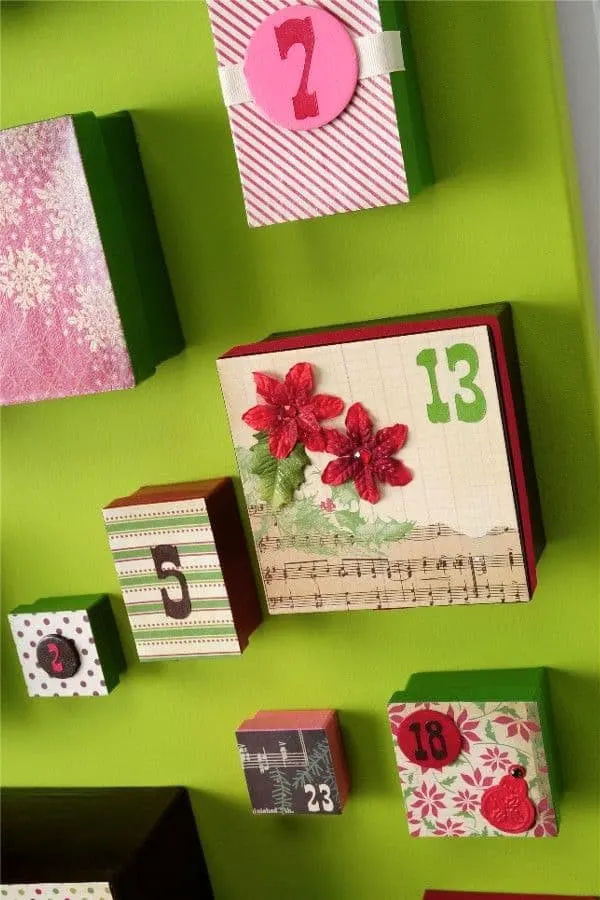 I wanted a DIY advent calendar that was going to make a huge statement, so I made this one using big boxes, a canvas, and my favorite holiday papers.