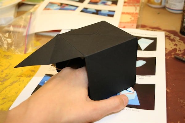 Folding black cardstock into a cube