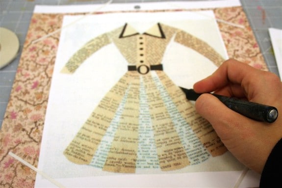 Cutting out a dress design from scrapbook paper with a craft knife