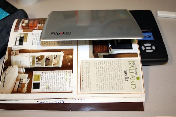 Scanning the pages of a Ballard Designs catalog on a portable scanner