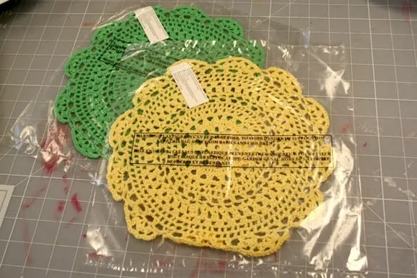 One green doily and one yellow doily from the Michaels dollar bins