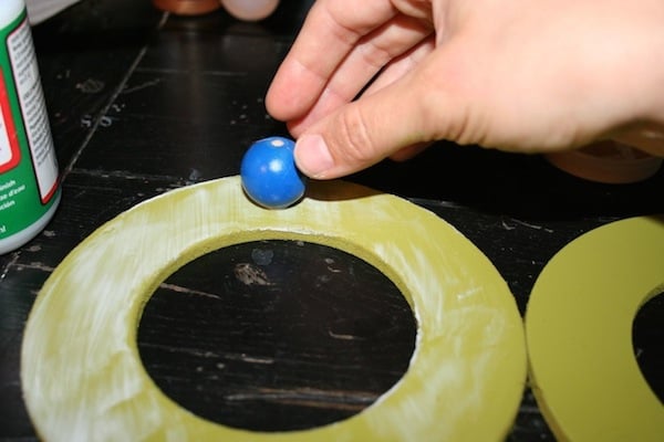 Glue the wood balls onto the wood circle with craft glue