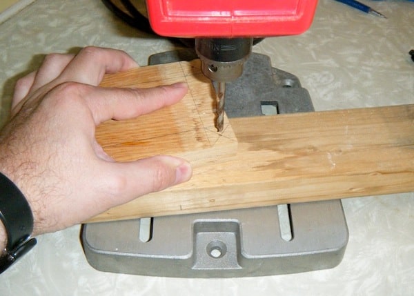 Using a drill press on a piece of plywood