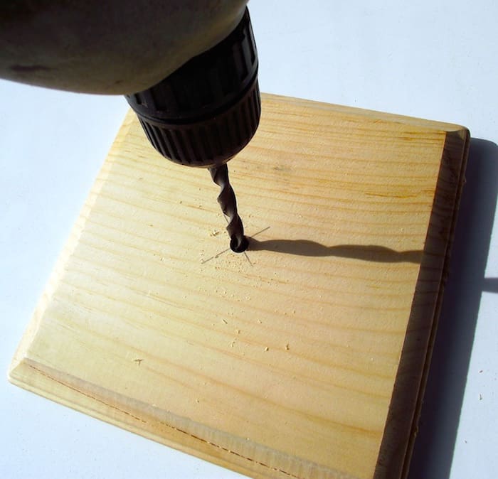 Drilling into the center of a wood plaque