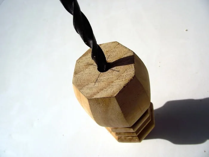 Drill into the base of the table leg