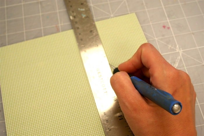 Cutting the paper with a craft knife and ruler