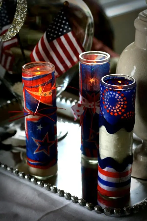 Make firecracker candles for Fourth of July using dollar store votives, napkins, and Mod Podge. These are so easy and look great for the holiday!