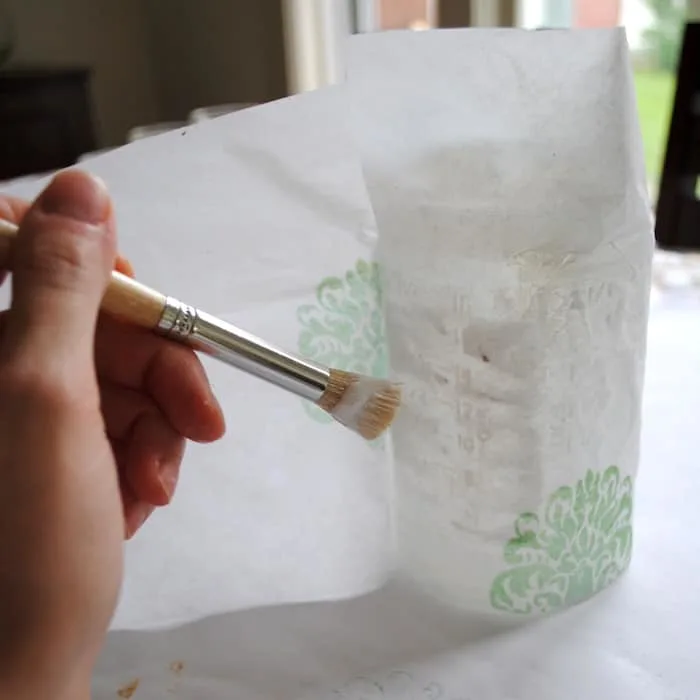 Decoupaging around the jar and tissue paper with Mod Podge