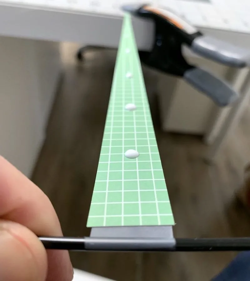 A paper triangle with dabs of glue