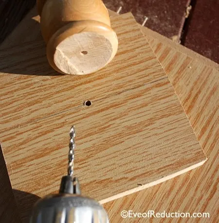 Drill a hole in the base of the crib spindle as well as the plywood