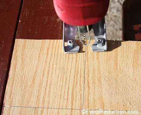 Cutting scrap plywood with a jigsaw to make candlestick holders