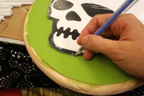 Tracing the skeleton graphic onto the plaque with a pencil