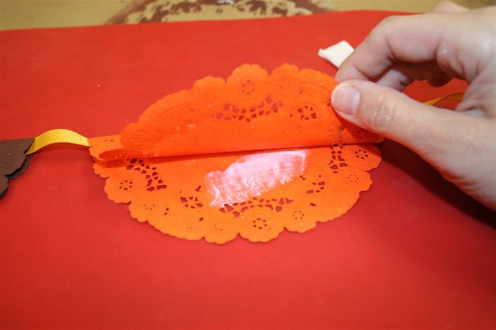Painting a thin layer of Mod Podge between the doily layers