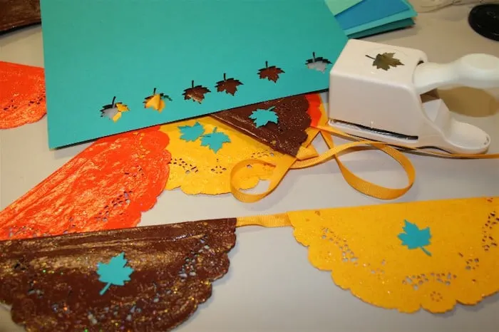Punching out leaves from paper using a craft punch