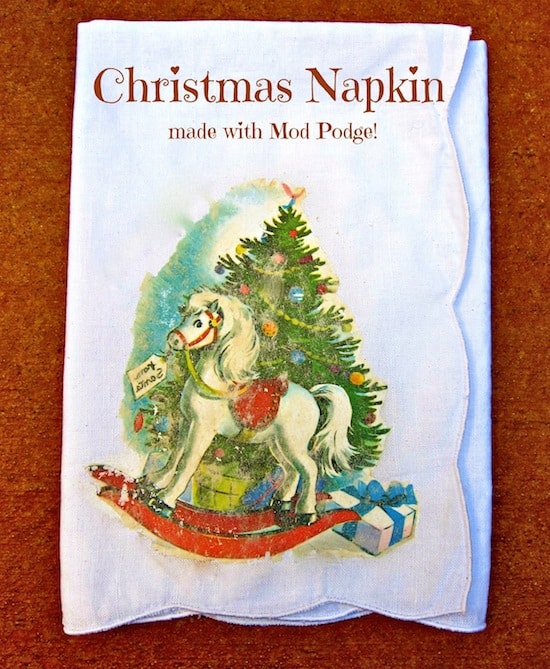 Use Mod Podge photo transfer medium to create these awesome Mod Podge photo transfer Christmas napkins - complete with a vintage holiday graphic!