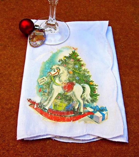 Use Mod Podge photo transfer medium to create these awesome Mod Podge photo transfer Christmas napkins - complete with a vintage holiday graphic!