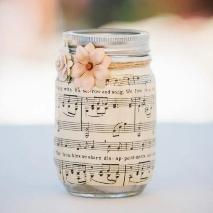 Maybe you need table decorations for a party or wedding on a budget? Mason jar centerpieces are a great idea - this one uses sheet music and Mod Podge.