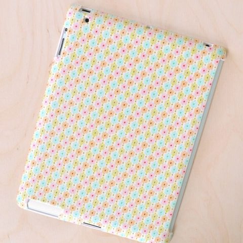 This DIY iPad case started as a $1 find from the dollar store! I then decoupaged a leftover fabric scrap to the outside, turning it into a custom case.