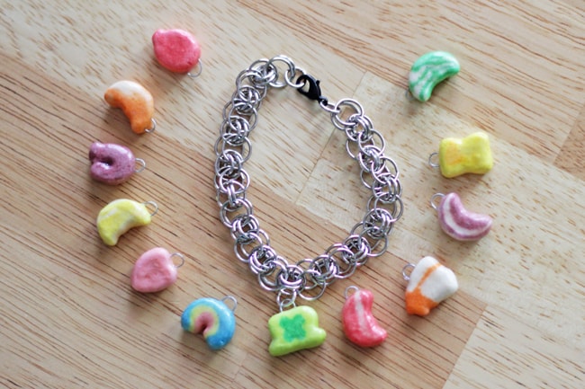 Lucky charms marshmallows laying next to a silver chain bracelet