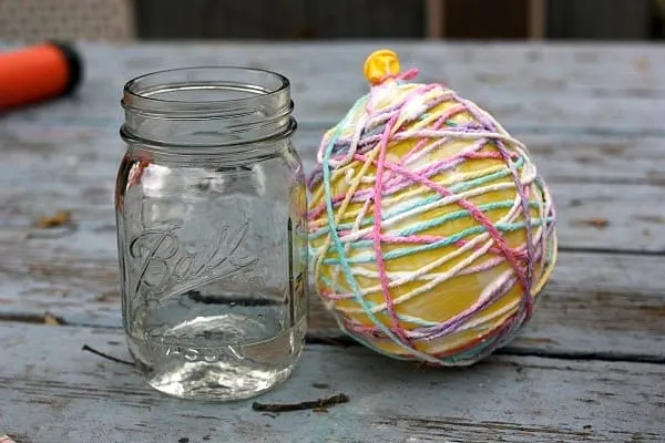 craft string around a balloon covered with Mod Podge