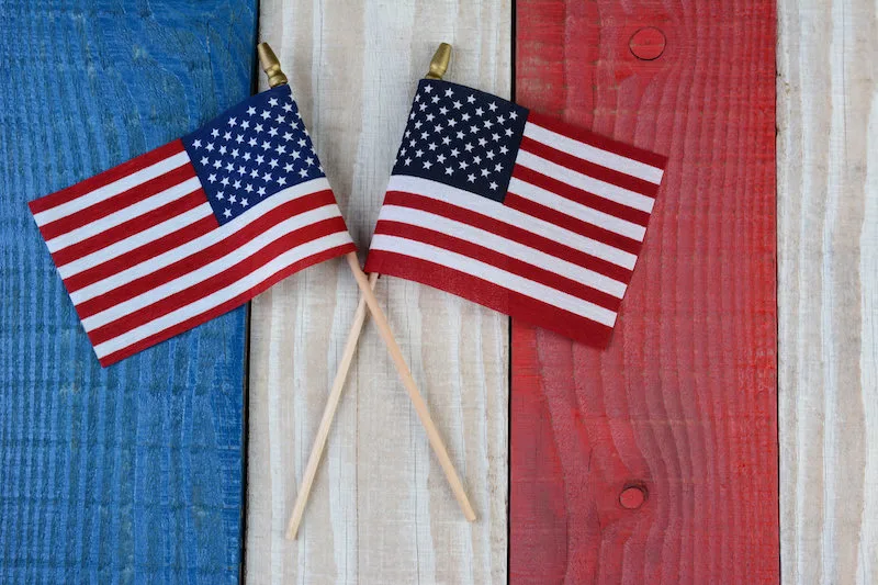 Two American Flags on Painted Wood Background