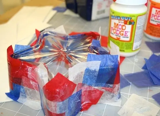 Applying red, white, and blue tissue paper to the star shaped glass dish
