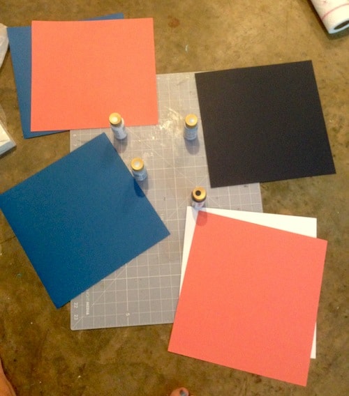 Piles of scrapbook paper matched up with paint colors