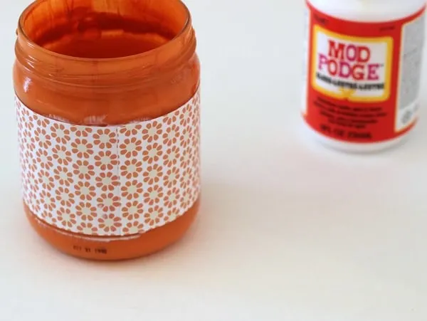 Applying paper to the outside of a glass jar