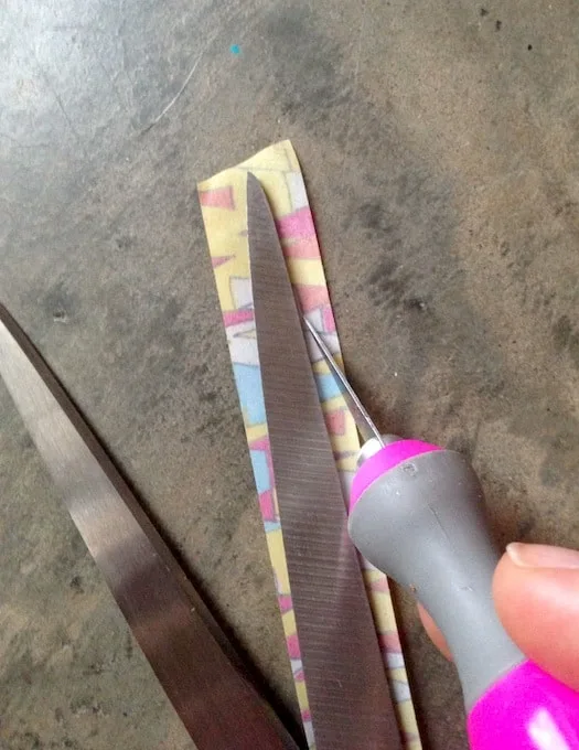 Trimming washi tape on the scissor blades with a craft knife