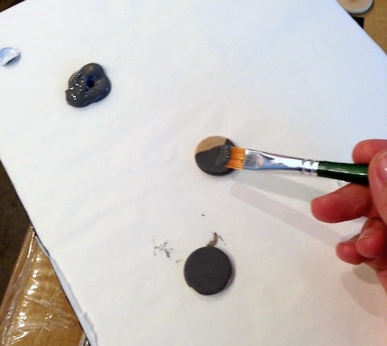 Painting the wood circles with gray paint