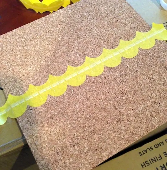 Attaching the scalloped tape to the cork board