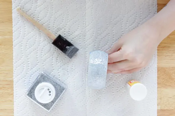Hand holding a glitter bangle that is drying