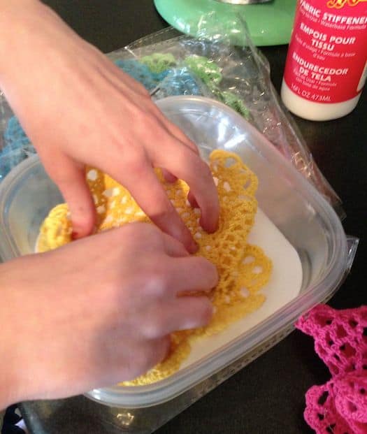 Soaking the dollies in the fabric stiffener