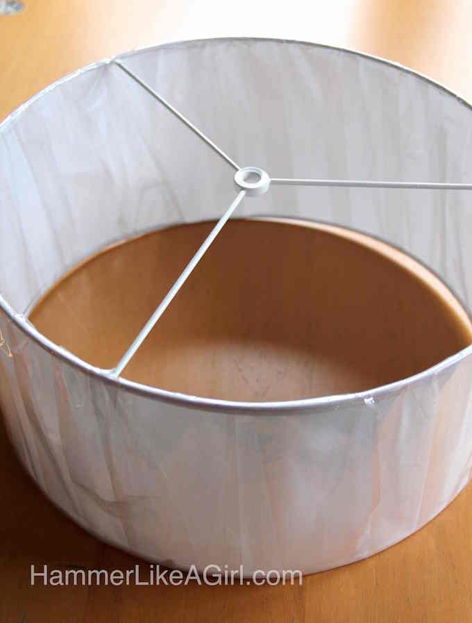 White drum lampshade in a plastic wrapper