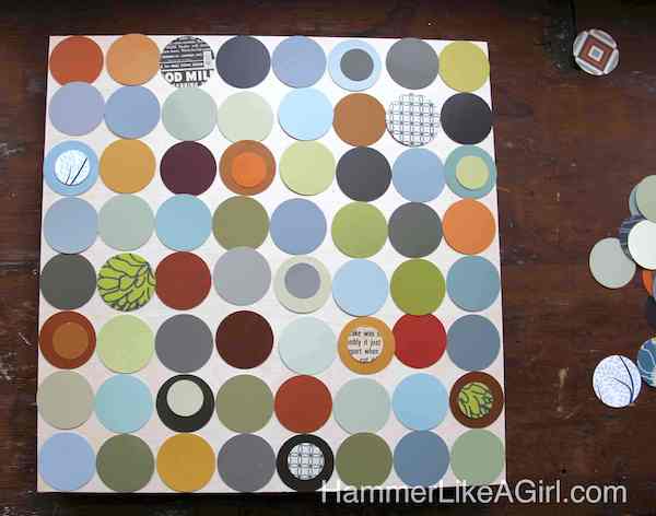 Paint chip circles arranged onto the wood elephant board