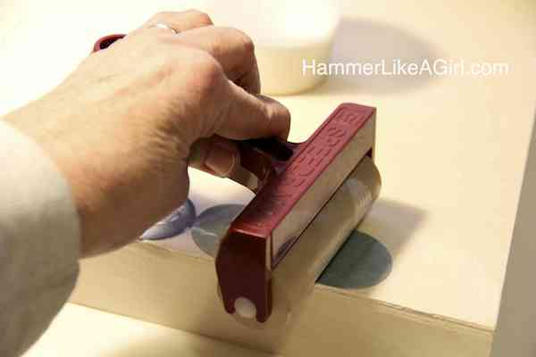 Rolling a brayer over the paint chips