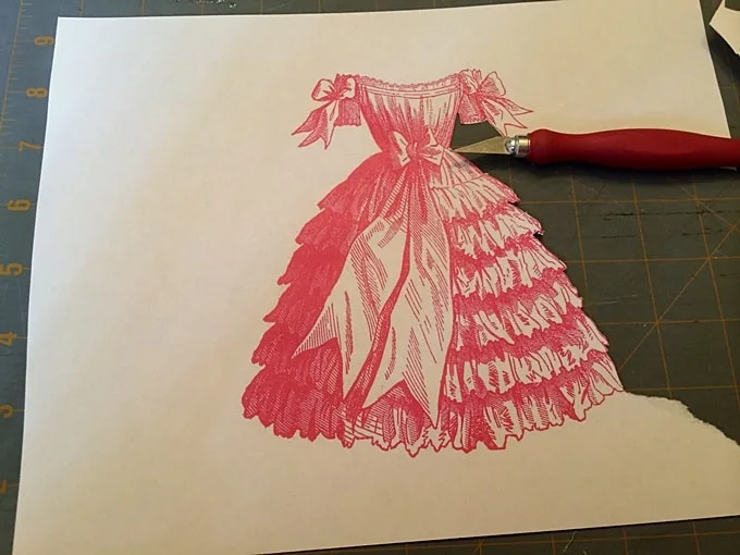 Trimming an image with a craft knife on a cutting mat