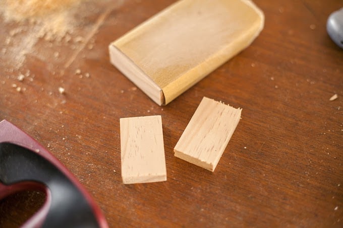 Sanding the blocks using a piece of sandpaper