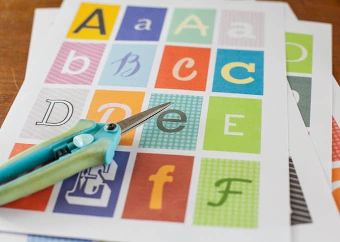 Printed letter sheets with a pair of scissors laying on top