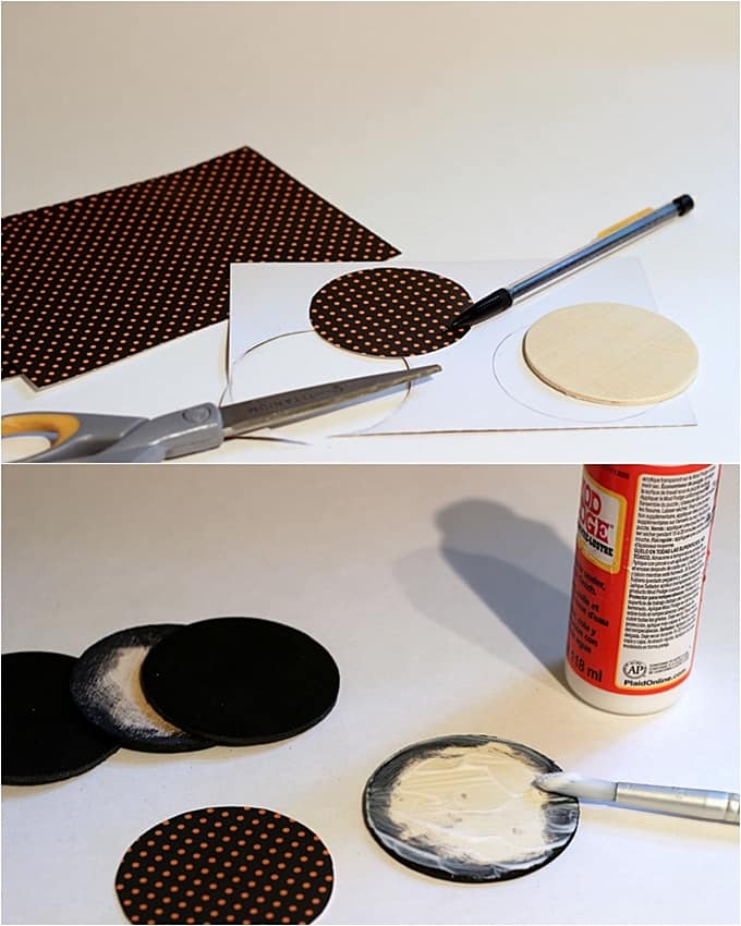 Tracing paper circles with a pen, cutting them out, and applying to the wood circles with Mod Podge