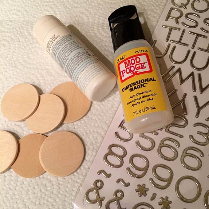 Wood circles, white acrylic paint, Dimensional Magic, and adhesive numbers