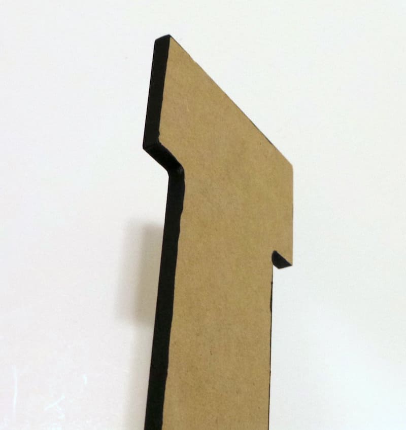 Wood letter painted with black craft paint on the edges